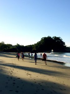 yoga group walking to beach